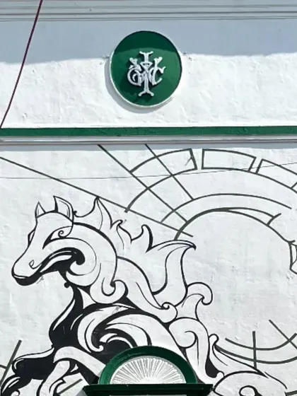 A different angle of the racecourse mural, showing how it integrates with the building's architecture.