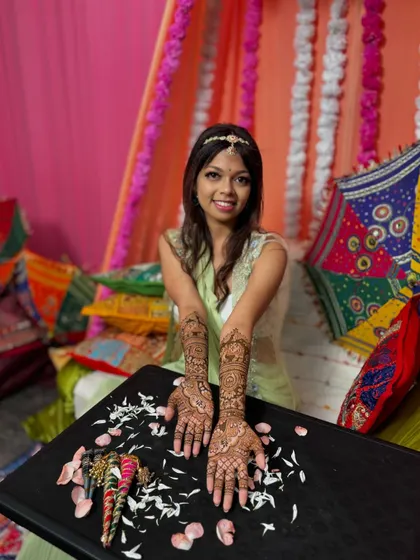 A beautiful shot of the bride with her completed mehendi, showcasing the artistry and the joy of the occasion.
