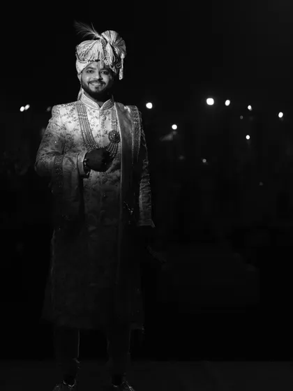 A dramatic black and white portrait of the groom, using low-key lighting to create a powerful image.