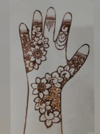 A design sketch on paper, mapping out a floral bail. This helps me perfect the flow and balance of the design before applying it to the skin.