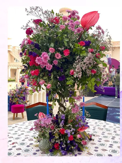Another example of a vibrant, multi-colored floral centerpiece used for the peacock-themed welcome lunch.