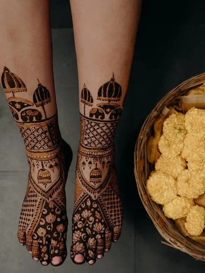 Another view of the ambari and jhumka feet design, this time with a basket of marigolds, adding to the festive wedding vibe.