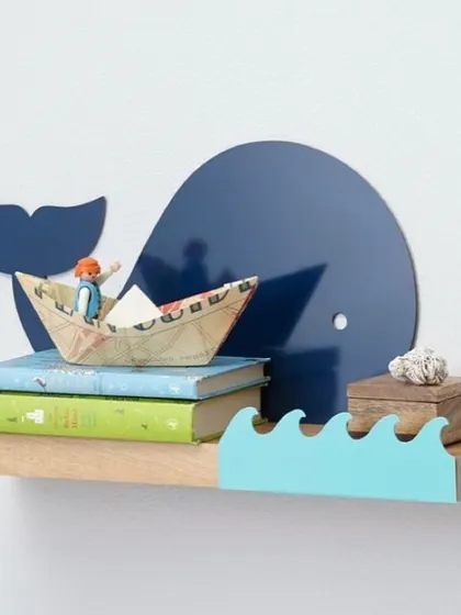 Have a whale of a time decorating with this adorable whale-shaped shelf. It's a playful design that brings a touch of the ocean to your child's room, perfect for holding small books and nautical treasures.