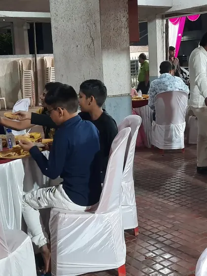Guests dining at the event. The chair covers add a touch of formality to the seating.