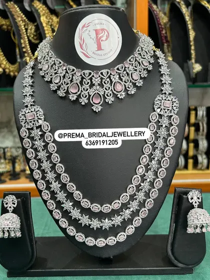 A layered AD set with pink stones and matching jhumkas.