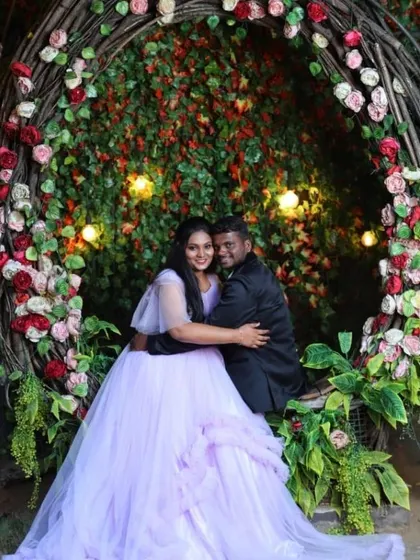 For another look, the couple changed into a dreamy lavender ruffle gown and a black suit, posing on a romantic floral swing.