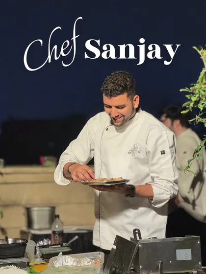 Meet Chef Sanjay, plating appetizers at an evening event. His attention to detail ensures every bite is perfect.