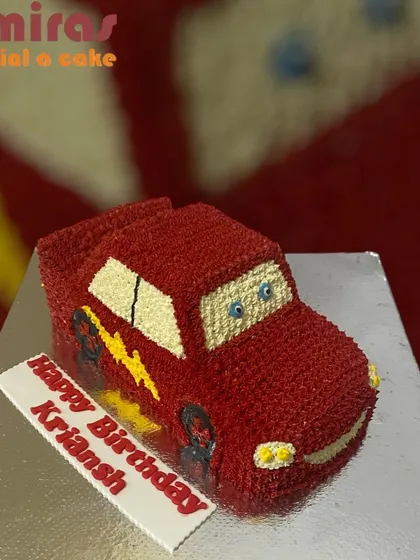 This buttercream car-shaped cake brings Lightning McQueen to the party. The entire cake is sculpted and decorated to look like the famous race car, making it a thrilling treat for a young fan.