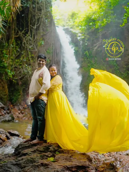 A stunning pre-wedding shoot set against a waterfall. The bright yellow flying gown I provided creates a brilliant contrast with the natural scenery.