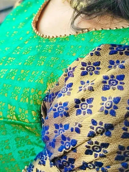 The details make the design. Here you can see the beautiful contrast between the green body of the dress and the blue and gold brocade used for the puff sleeves, all from the original saree.