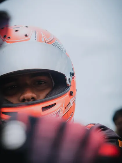 A close up of a driver's eyes in his helmet.