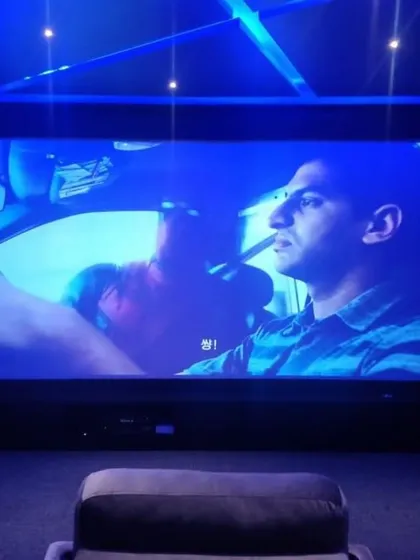 This is the view from your seat. We meticulously plan screen size and seating distance to create an engaging cinematic experience, complemented by ambient ceiling lights that don't distract from the picture.