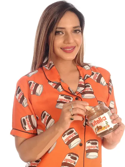 My Nutella print pajama set is a bestseller for a reason. This fun, vibrant orange design is printed on my signature butter-soft cotton, making it perfect for cozy nights and sweet dreams. It’s a playful nod to everyone's favorite chocolate hazelnut spread.