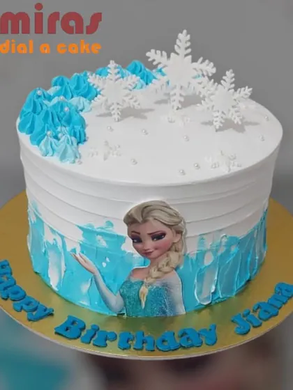 A beautiful single-tier Frozen cake with an edible image of Elsa. The design is enhanced with icy blue frosting and delicate white snowflakes, perfect for a magical birthday celebration.