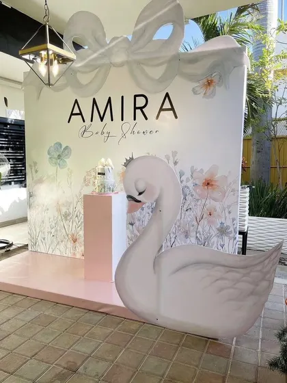 An elegant swan-themed baby shower for Amira. The large swan prop and delicate floral backdrop create a graceful and sophisticated ambiance for the celebration.