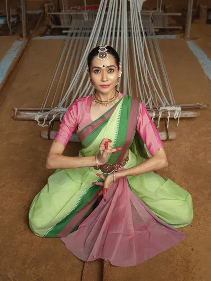 A seated pose in front of a loom, from a photoshoot celebrating the heritage of Jamakalam weaving. The project aimed to weave dance into the fabric of Tamil Nadu's landscapes.