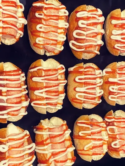 Mini hot dogs ready to be served. These bite-sized snacks are perfect for little hands and are always a hit at parties.
