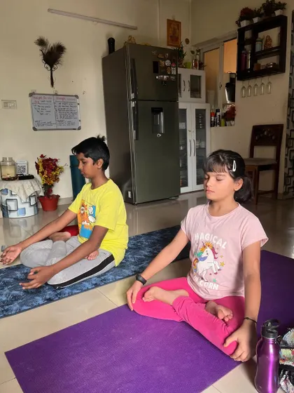 Two children sit in a meditative pose, learning to quiet their minds and focus their attention. These are invaluable skills for life.