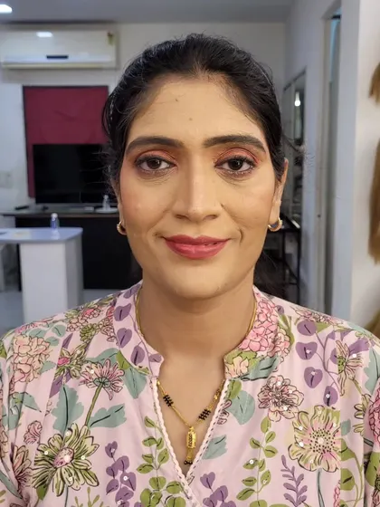 Another view of the corrective makeup, showing how it enhances the natural bone structure with soft contouring and blush.