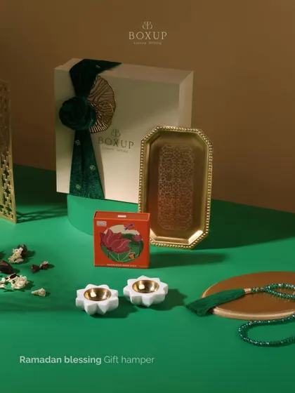 Celebrate the spirit of Ramadan with our "Ramadan Blessing Gift Hamper." This elegant set includes a decorative brass tray, lotus candle holders, and other items perfect for Iftar gatherings.
