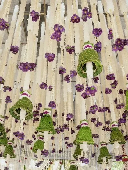 A close-up of the intricate ceiling decoration, made of jasmine, orchids, and woven leaf bells.