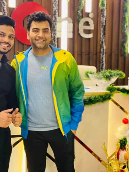 A trainer and member sharing a happy moment, embodying the positive and encouraging spirit of our gym.