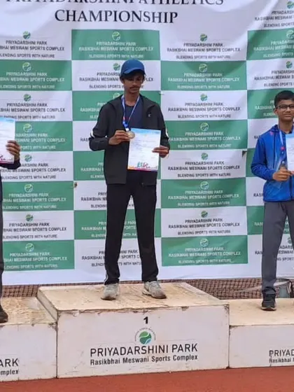 Aston Mascarenhas on the podium after winning a bronze medal in the U-16 800m race.