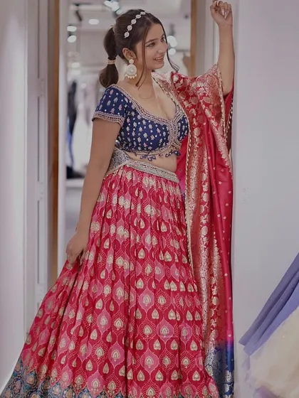 Unleash your inner diva in this dazzling vibrant lehenga. The combination of a royal blue blouse and a pink printed skirt is a head-turner, perfect for a sangeet.