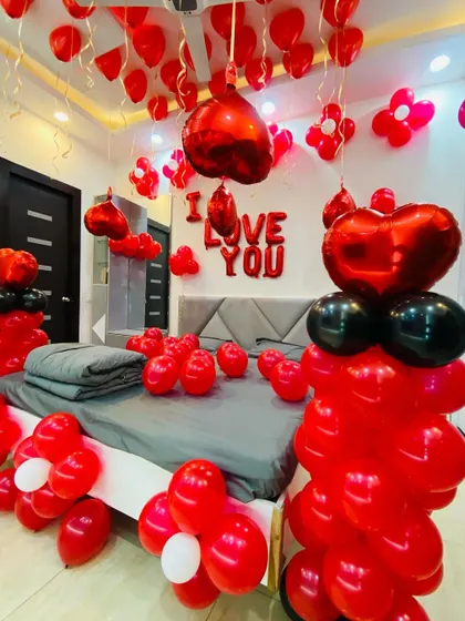 A vibrant red and black balloon decoration for a romantic surprise, filling the room with color and love.