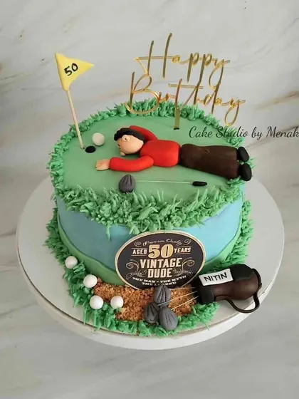 A golf themed 50th birthday cake for a 'Vintage Dude'. I had fun creating this scene of a golfer on the green, complete with a golf bag and balls.