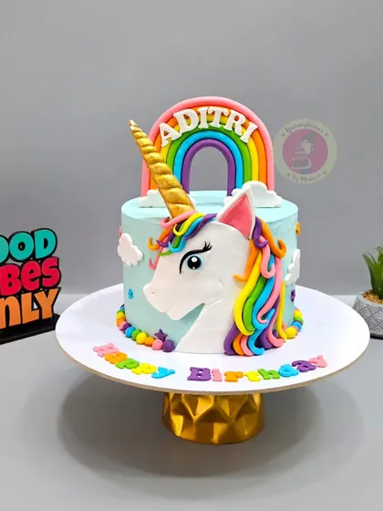 A magical unicorn cake with a rainbow mane and a golden horn. This is one of my most requested designs for little girls.