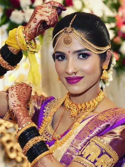 A confident and poised bridal portrait, with the bride posing against a floral background.