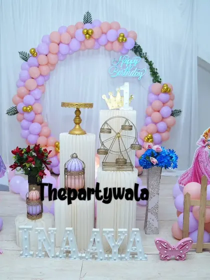 This Princess Sofia theme uses a soft purple and peach color palette, complete with character cutouts and a beautiful balloon ring.