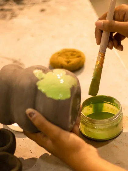 The second step of Mishima: applying a vibrant green slip into the carved designs. This color will remain after the excess is wiped away.