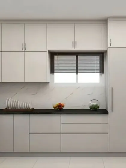 An all-white L-shaped kitchen that feels bright and spacious. The black countertop and integrated appliances provide a modern contrast.