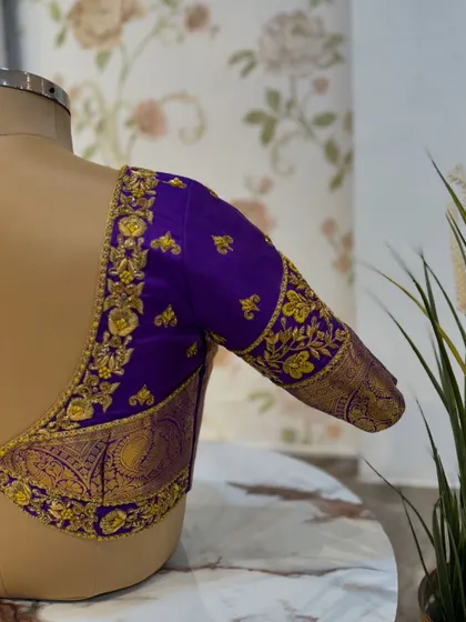 A side view of the purple blouse, showing the depth of the embroidery work on the sleeve.