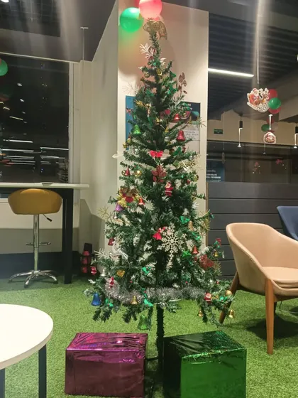 Here is another Christmas tree we decorated for a corporate lounge area. We used a variety of colourful ornaments and placed wrapped gift boxes at the base to complete the festive look.