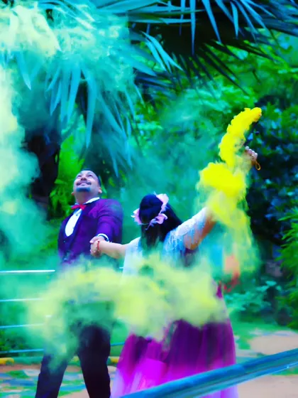 A playful and vibrant shot with the couple using two different colored smoke bombs.