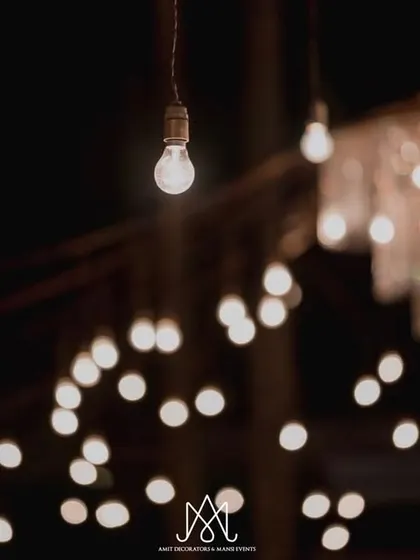 A close-up shot of a single hanging bulb, with a beautiful bokeh of other lights in the background, proving that the smallest details can have the biggest impact.
