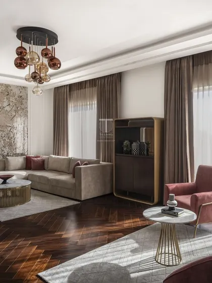 In this living room, we used a mix of textures and forms to create a sophisticated space. The L-shaped sofa, curved armchairs, and stone-topped tables were all crafted by us to create a luxurious yet comfortable environment.
