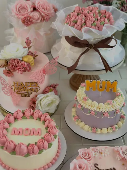 A beautiful spread of our Mother's Day cakes, featuring various floral designs, colors, and messages like "Mom," "Mum," and "Super Mom."