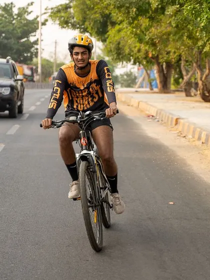 A young cyclist confidently rides on the road during the Tour de Forest event.