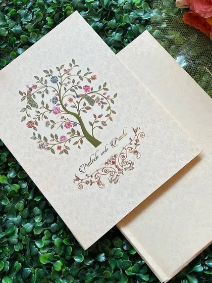 A charming invitation featuring a "tree of life" design with colorful flowers and birds, symbolizing growth and new beginnings.