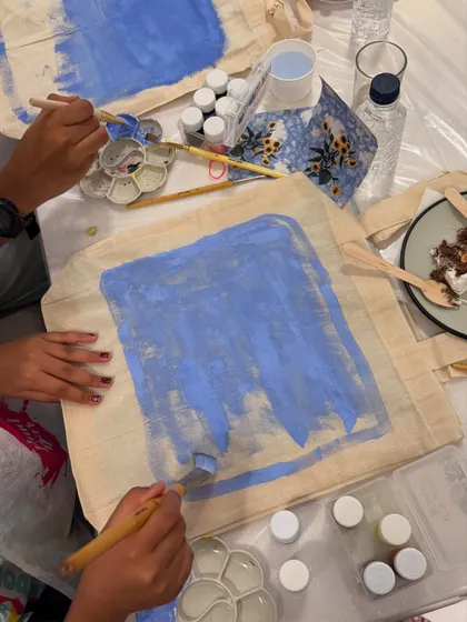 A close-up of a sunflower tote bag painting from a kids' birthday party. The bright colors and cheerful design were a huge hit.