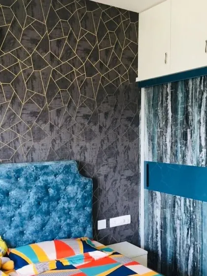 A modern bedroom deserves a modern touch. This dark, textured wallpaper with gold geometric lines adds a layer of sophistication and drama, serving as a perfect accent wall behind the bed.