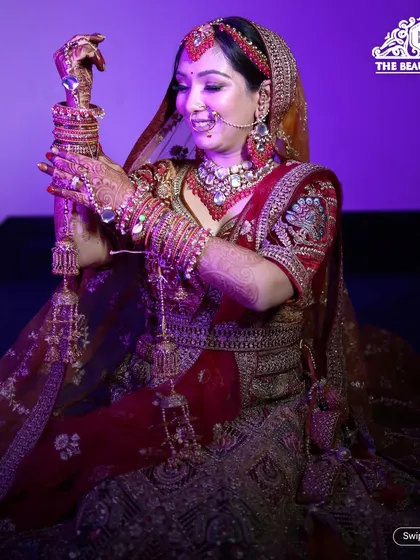 A candid moment of a bride with her kirpan. The makeup is traditional and radiant, designed to look perfect throughout the wedding rituals.