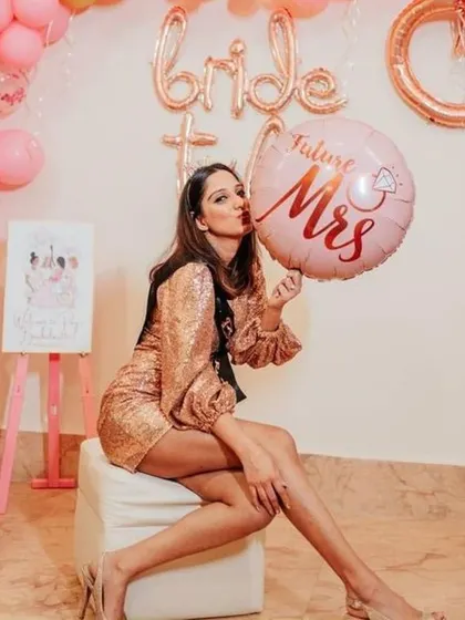 A solo shot of the "Future Mrs." looking glamorous with her themed balloon and decor. We make sure the bride-to-be feels like the star of the show.