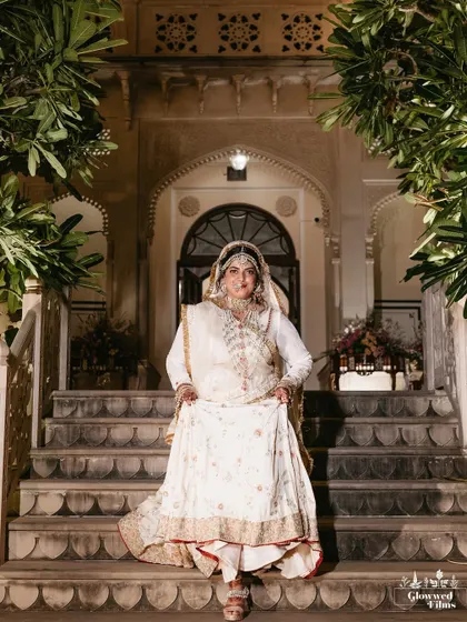 A regal portrait of the bride, Ishaana, posing on the steps of the Khas Bagh palace in Jaipur, looking like royalty.