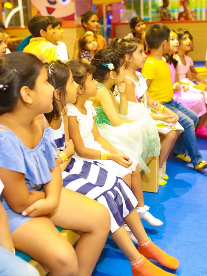 An audience of excited children watches a performance. My party packages can include entertainment and shows that keep all the young guests captivated and delighted.