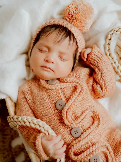 A peaceful slumber in a cozy basket. The soft textures and warm tones make this newborn photo feel so serene.